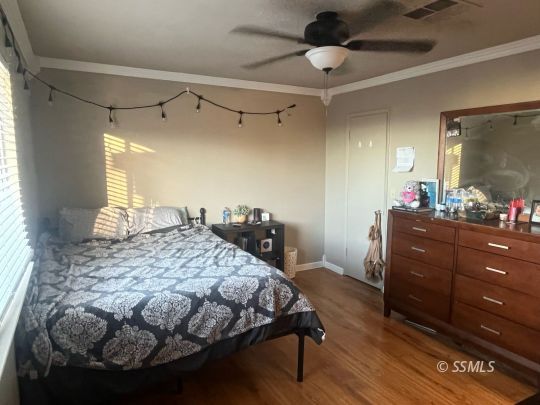 133 South Locust Street Ridgecrest, CA 93555 - Photo 16 of 26 a bedroom with a bed and a mirror on the dresser