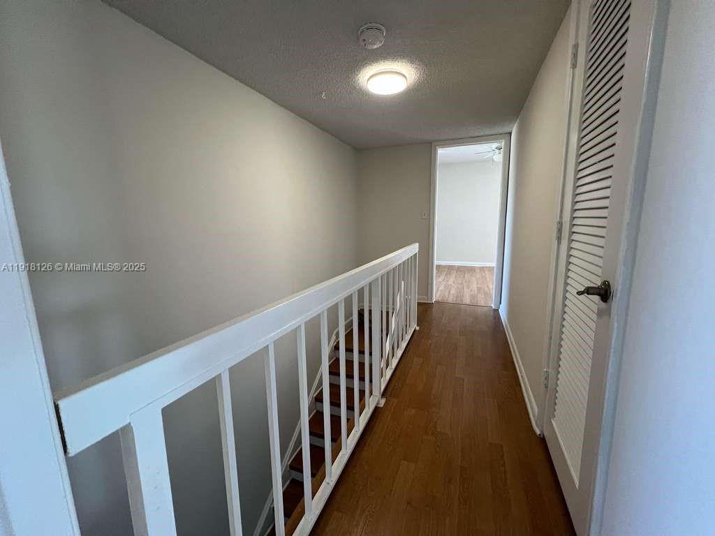 721 Southeast 1st Way, Unit B18 Deerfield Beach, FL 33441 - Photo 11 of 22 a view of a hallway with wooden floor