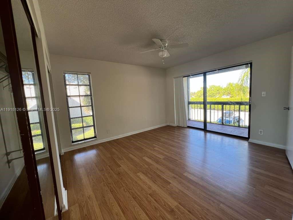 721 Southeast 1st Way, Unit B18 Deerfield Beach, FL 33441 - Photo 12 of 22 an empty room with wooden floor and windows