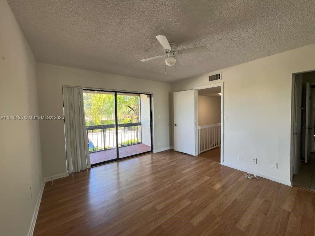 721 Southeast 1st Way, Unit B18 Deerfield Beach, FL 33441 - Photo 13 of 22 an empty room with wooden floor and windows