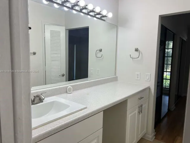 a bathroom with a sink and a large mirror