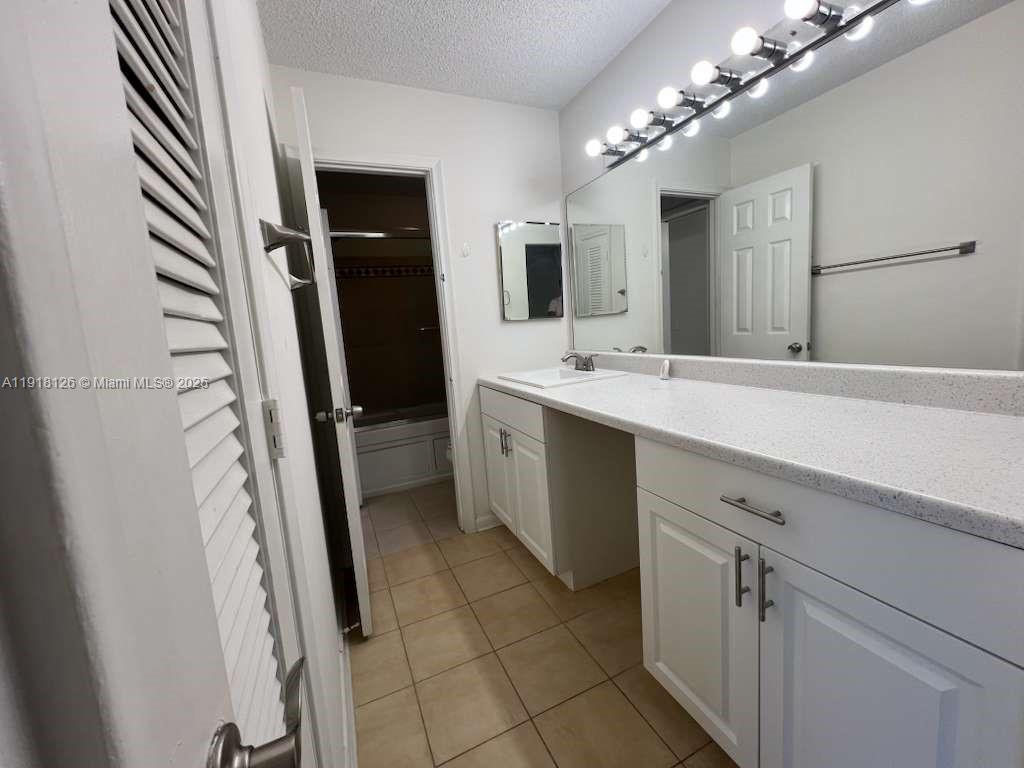 721 Southeast 1st Way, Unit B18 Deerfield Beach, FL 33441 - Photo 15 of 22 a spacious bathroom with a double vanity sink and mirror