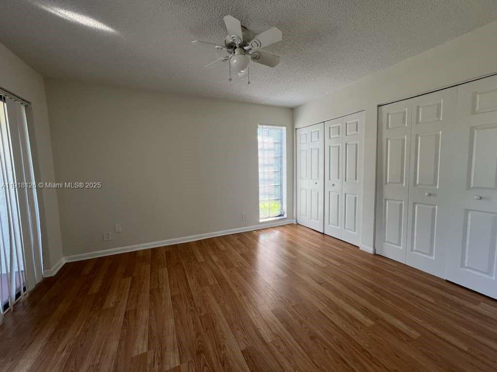 721 Southeast 1st Way, Unit B18 Deerfield Beach, FL 33441 - Photo 18 of 22 wooden floor in an empty room with a window