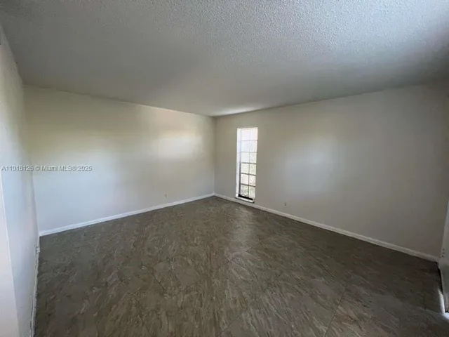 an empty room with a empty space and window