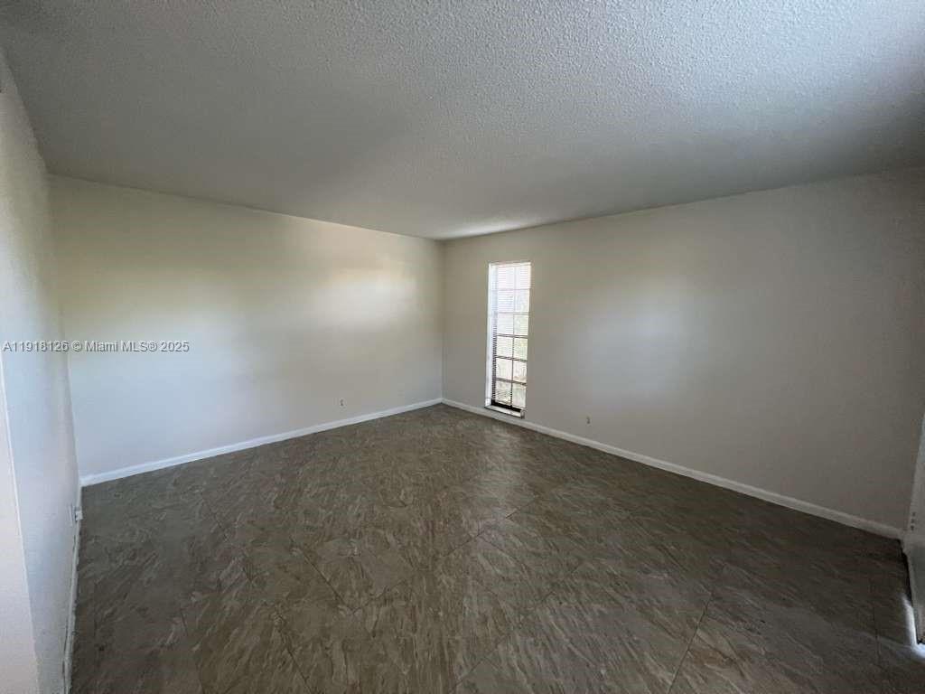 721 Southeast 1st Way, Unit B18 Deerfield Beach, FL 33441 - Photo 4 of 22 an empty room with a empty space and window