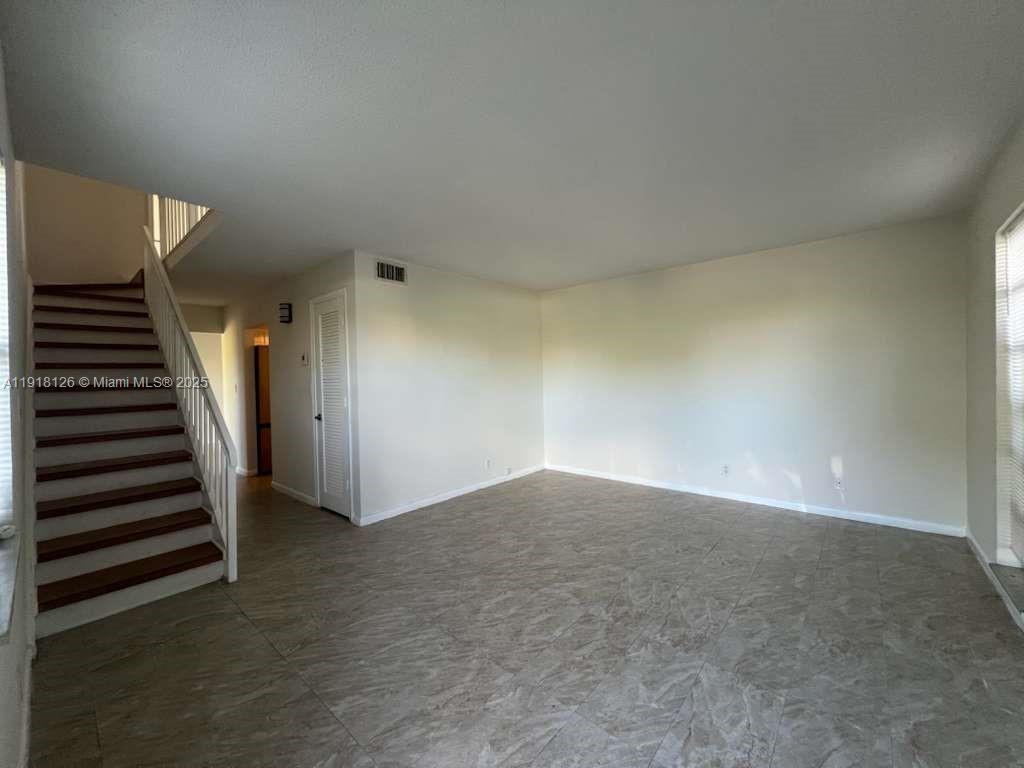 721 Southeast 1st Way, Unit B18 Deerfield Beach, FL 33441 - Photo 5 of 22 a view of an empty room with stairs