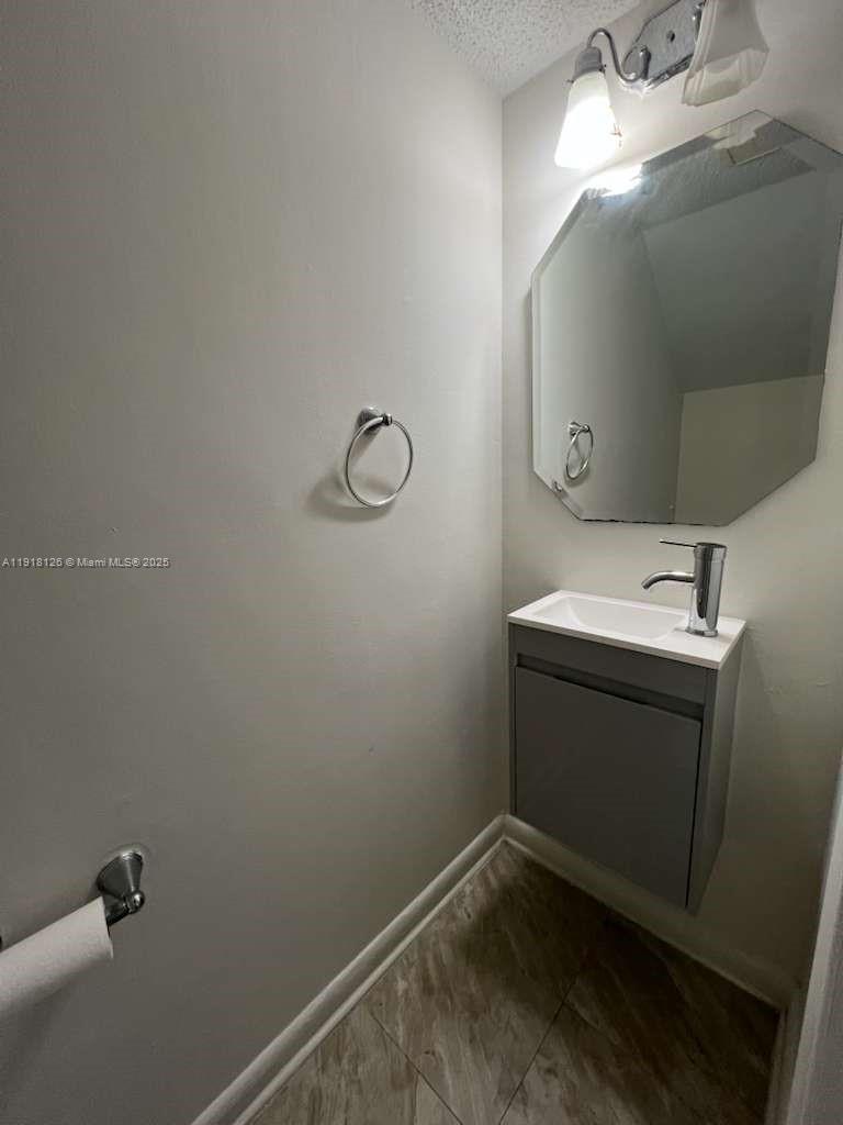 721 Southeast 1st Way, Unit B18 Deerfield Beach, FL 33441 - Photo 8 of 22 a bathroom with a sink and mirror