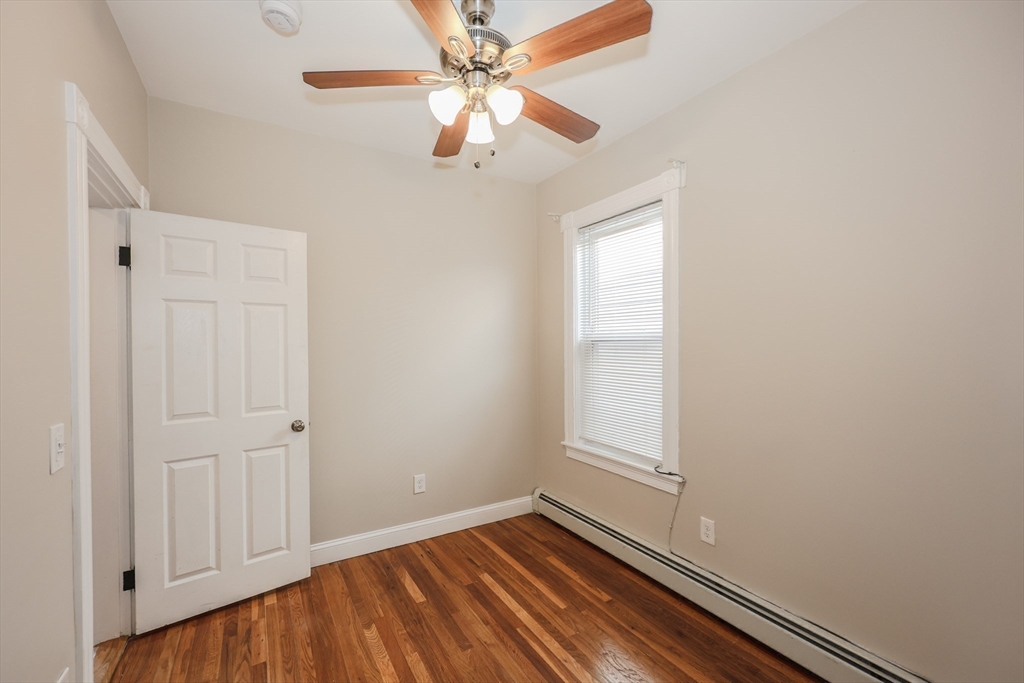 64 Bremen Street Boston, MA 02128 - Photo 11 of 42 an empty room with windows and fan