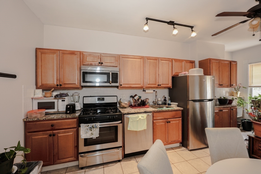 64 Bremen Street Boston, MA 02128 - Photo 21 of 42 a kitchen with a stove a refrigerator and a microwave