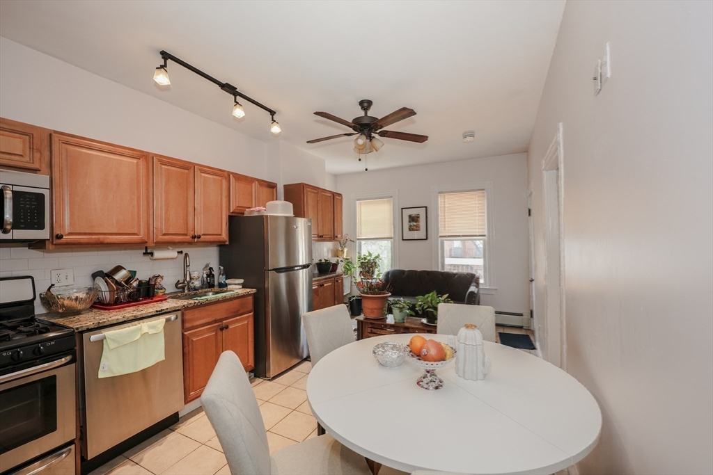 64 Bremen Street Boston, MA 02128 - Photo 22 of 42 a kitchen with stainless steel appliances a sink a stove a refrigerator and cabinets