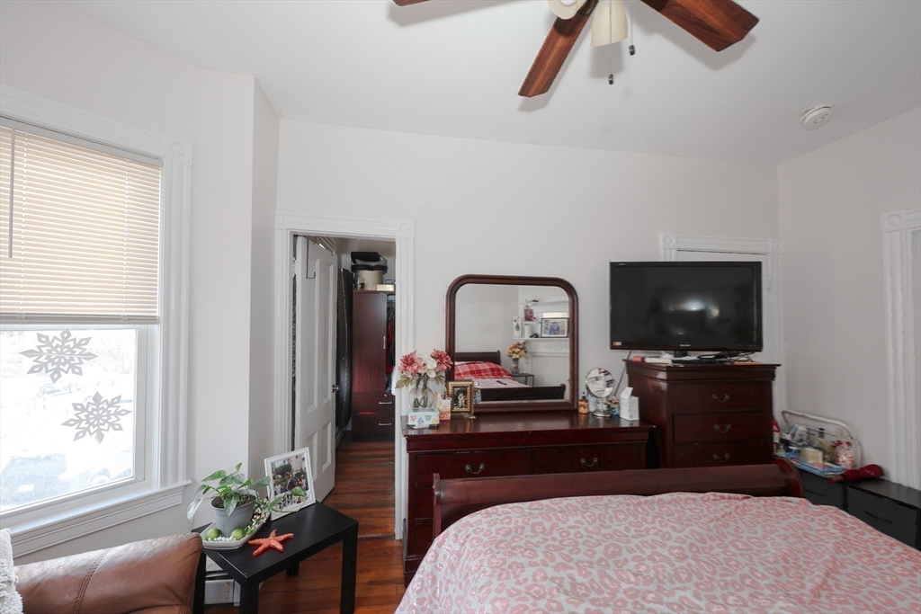 64 Bremen Street Boston, MA 02128 - Photo 24 of 42 a bedroom with a bed and a flat screen tv