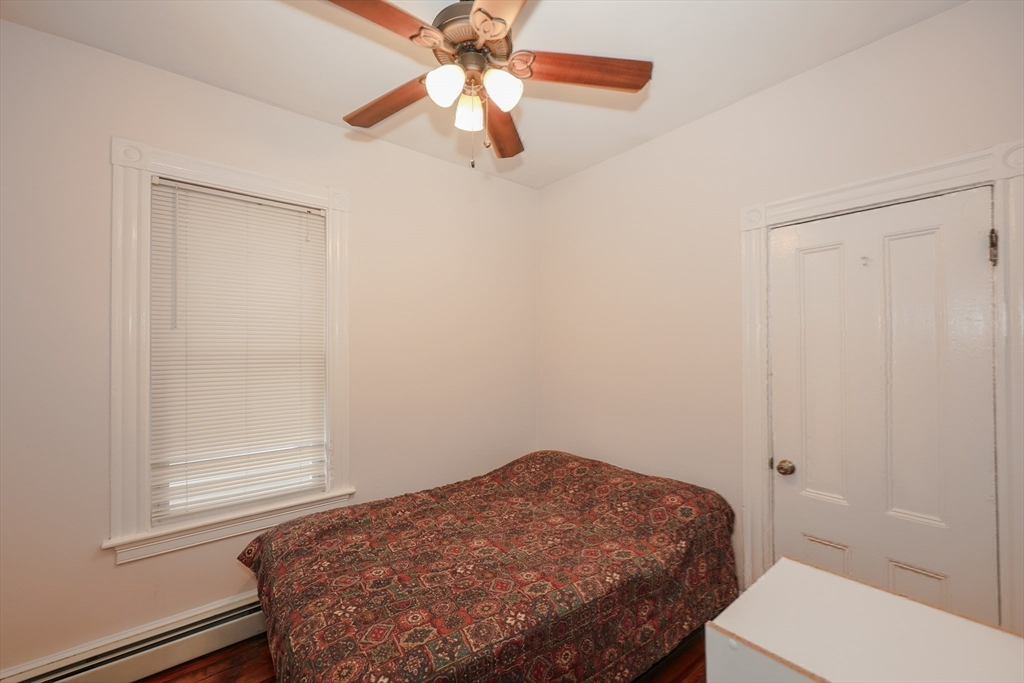 64 Bremen Street Boston, MA 02128 - Photo 26 of 42 a bedroom with a bed and a window