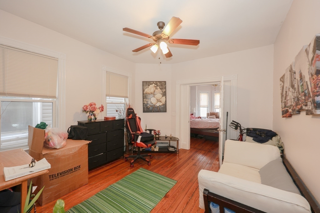 64 Bremen Street Boston, MA 02128 - Photo 28 of 42 a living room with furniture and a wooden floor