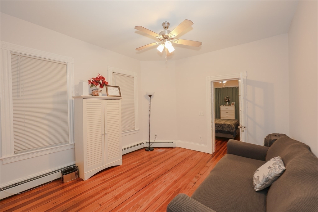 64 Bremen Street Boston, MA 02128 - Photo 34 of 42 a bed room with a bed and a chandelier
