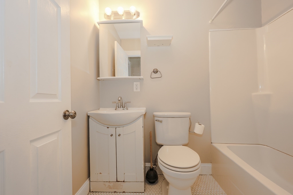 64 Bremen Street Boston, MA 02128 - Photo 8 of 42 a bathroom with a sink toilet and a mirror