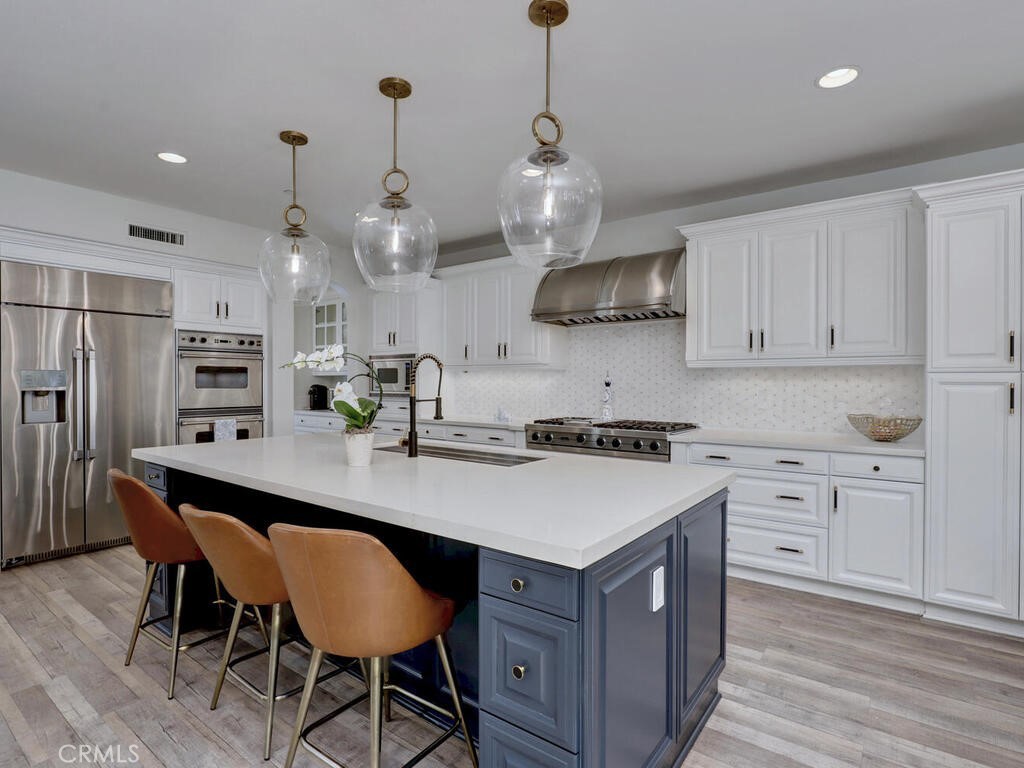 1 Lennox Court Ladera Ranch, CA 92694 - Photo 20 of 68 Central island with quartz countertops and pendant lighting above.