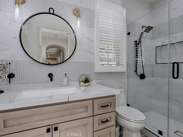 a spacious bedroom with a bed a couch and a dresser