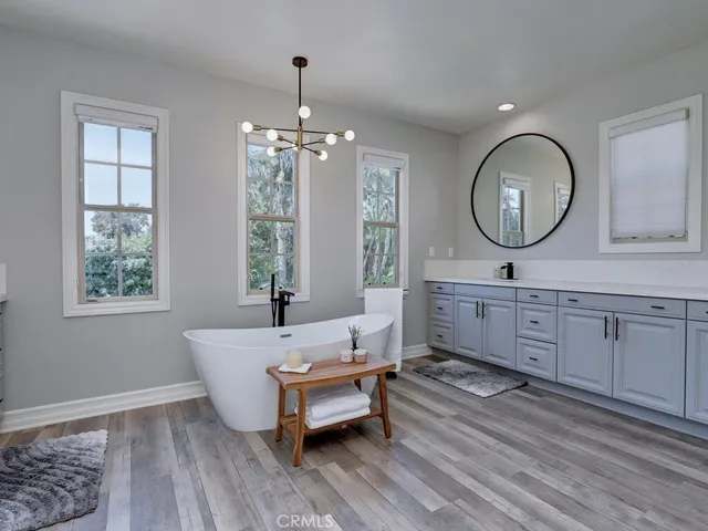 a bathroom with a toilet sink vanity and shower