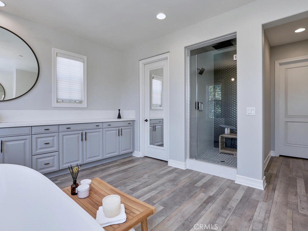 1 Lennox Court Ladera Ranch, CA 92694 - Photo 36 of 68 The mirrored door to the left and the other door to the right, lead to the two walk in closet areas-joined in the center. Custom tile in the shower.