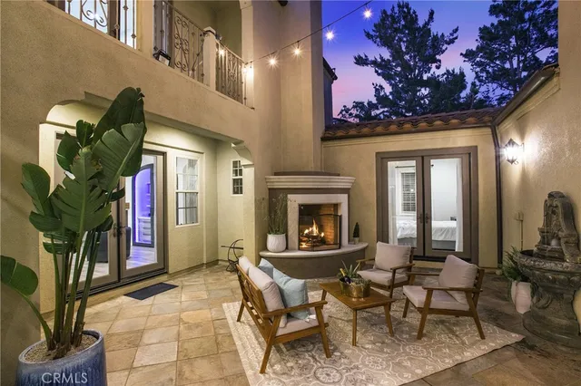 a living room with furniture a chandelier and a fireplace