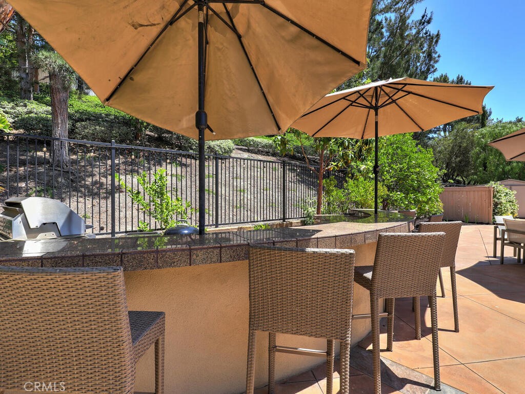 1 Lennox Court Ladera Ranch, CA 92694 - Photo 56 of 68 BBQ Island includes BBQ, double burner, and a spot for a small refrigerator, as well as two spots for umbrellas.