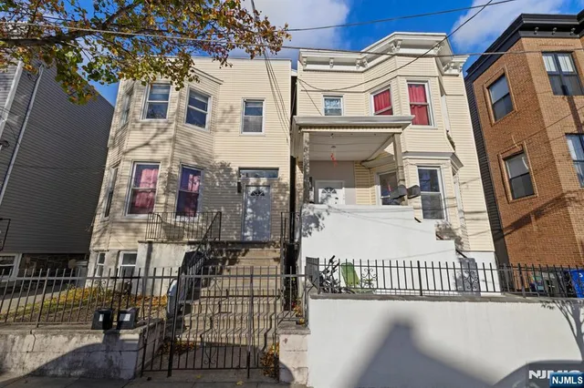 a view of a brick building with many windows