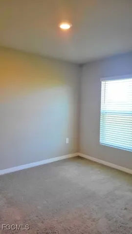 an empty room with a empty space and a window