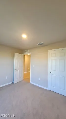 an empty room with a empty space and windows