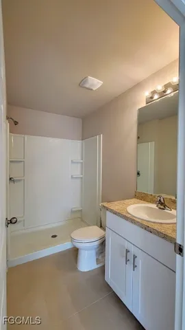 a bathroom with a granite countertop sink a toilet and bathtub