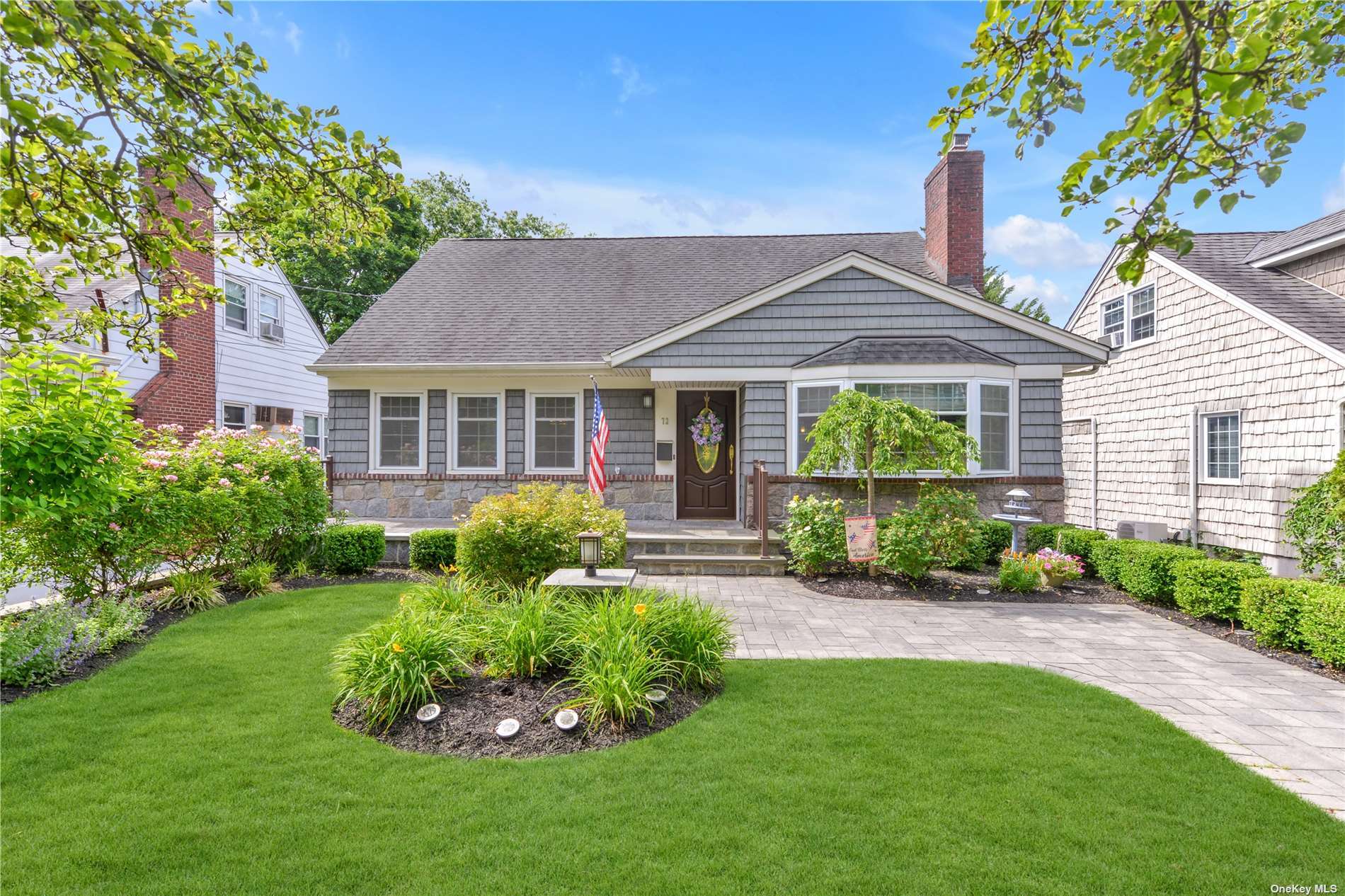 72 Hillside Avenue Williston Park, NY 11596 - Photo 1 of 1 a front view of a house with a yard and porch