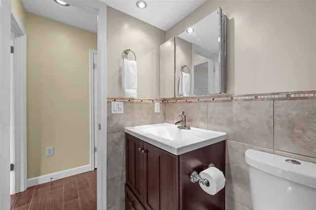 an aerial view of residential houses with outdoor space and lake view