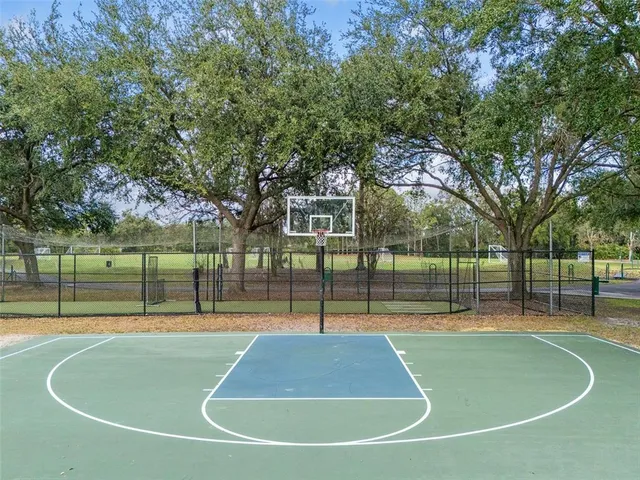a view of a patio with dining table and chairs with wooden floor