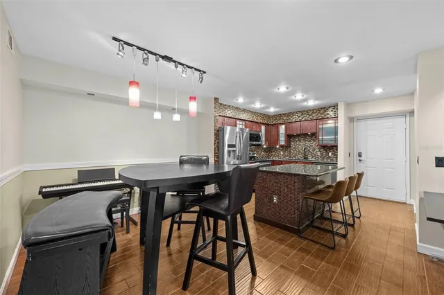a bedroom with a bed lamp and a large window