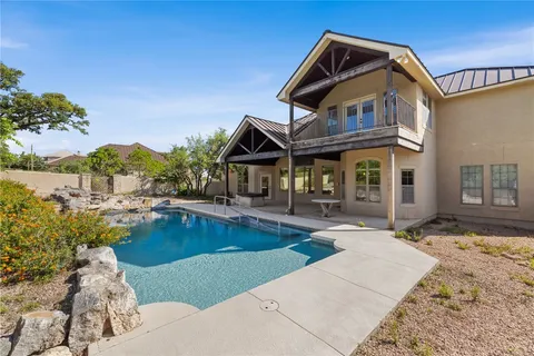 a front view of a house with swimming pool having outdoor seating