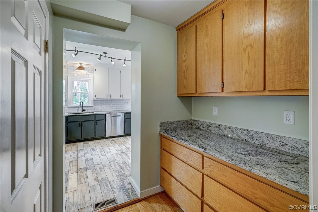 5304 Ditchley Road Richmond, VA 23226 - Photo 15 of 41 a kitchen with granite countertop stainless steel appliances a sink and cabinets