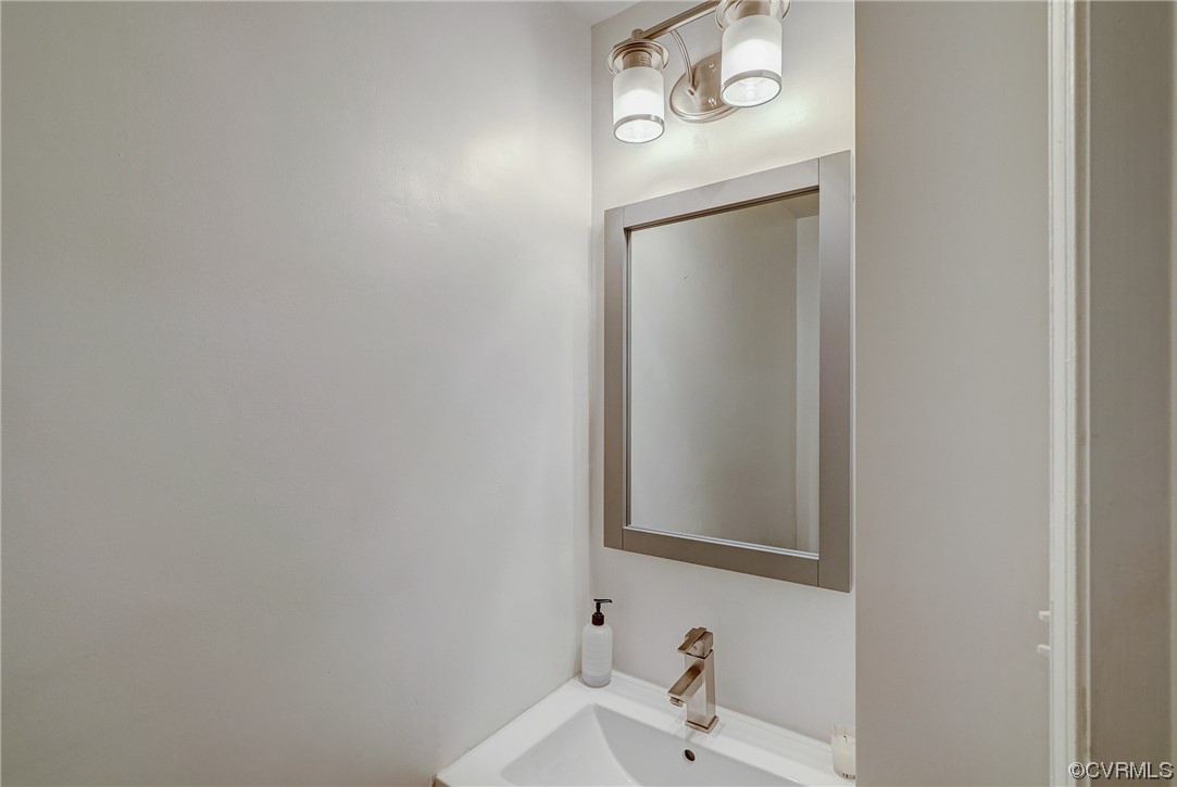 5304 Ditchley Road Richmond, VA 23226 - Photo 16 of 41 a bathroom with a sink and a mirror