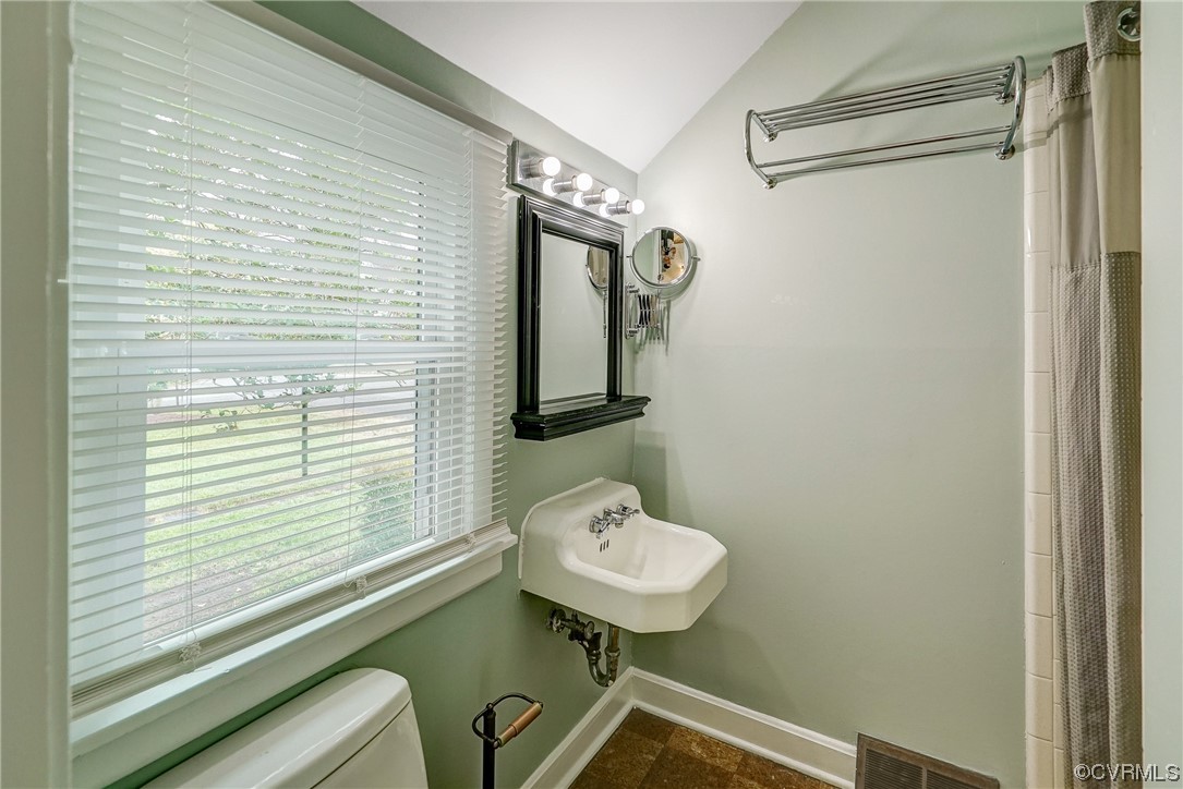 5304 Ditchley Road Richmond, VA 23226 - Photo 18 of 41 a bathroom with a sink a mirror and a toilet