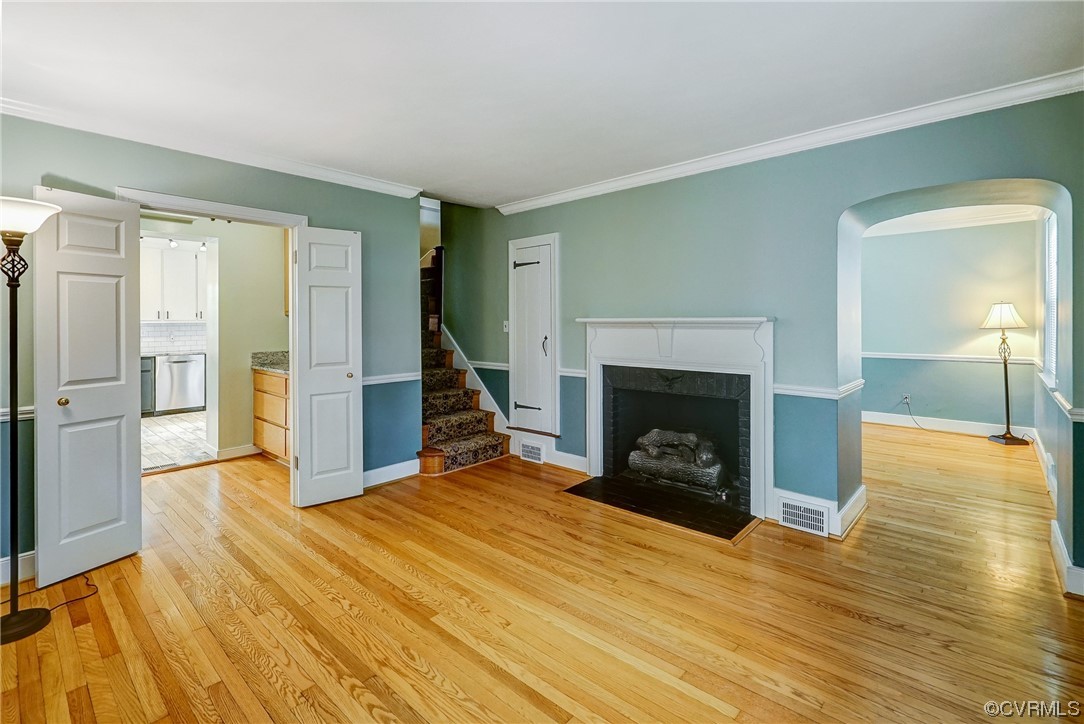 5304 Ditchley Road Richmond, VA 23226 - Photo 2 of 41 a view of a livingroom with wooden floor fireplace and a window