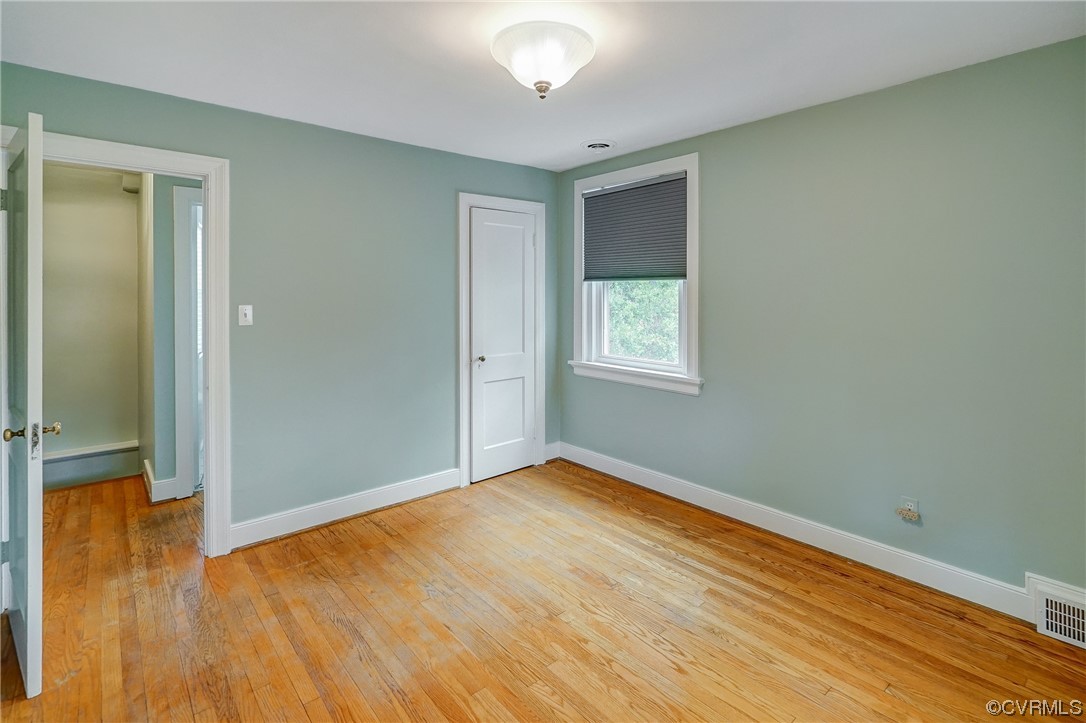 5304 Ditchley Road Richmond, VA 23226 - Photo 22 of 41 an empty room with wooden floor and windows