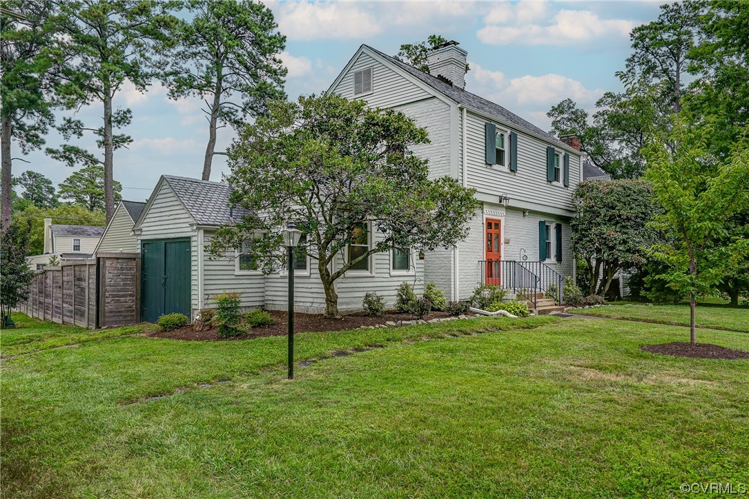 5304 Ditchley Road Richmond, VA 23226 - Photo 40 of 41 a house that is sitting in the grass and the view of trees in the background