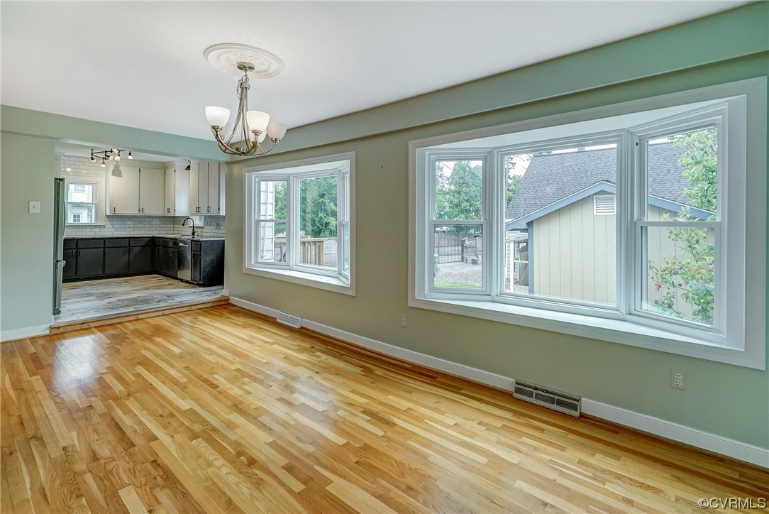 5304 Ditchley Road Richmond, VA 23226 - Photo 7 of 41 a view of an empty room with a window and wooden floor