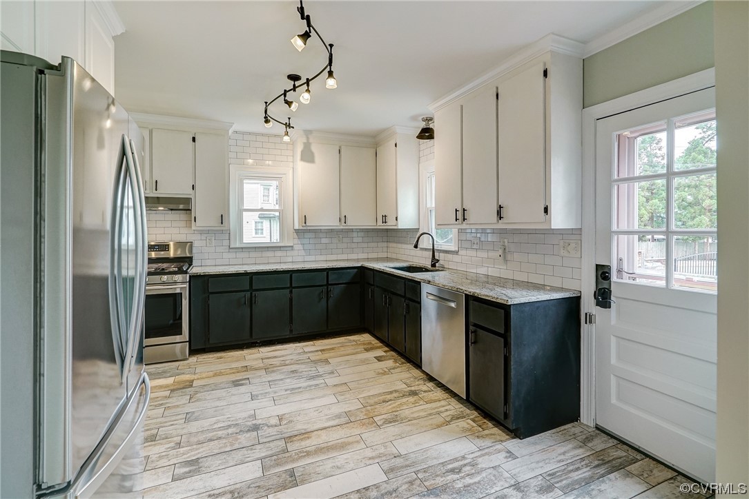 5304 Ditchley Road Richmond, VA 23226 - Photo 10 of 41 a kitchen with stainless steel appliances granite countertop a sink stove and refrigerator