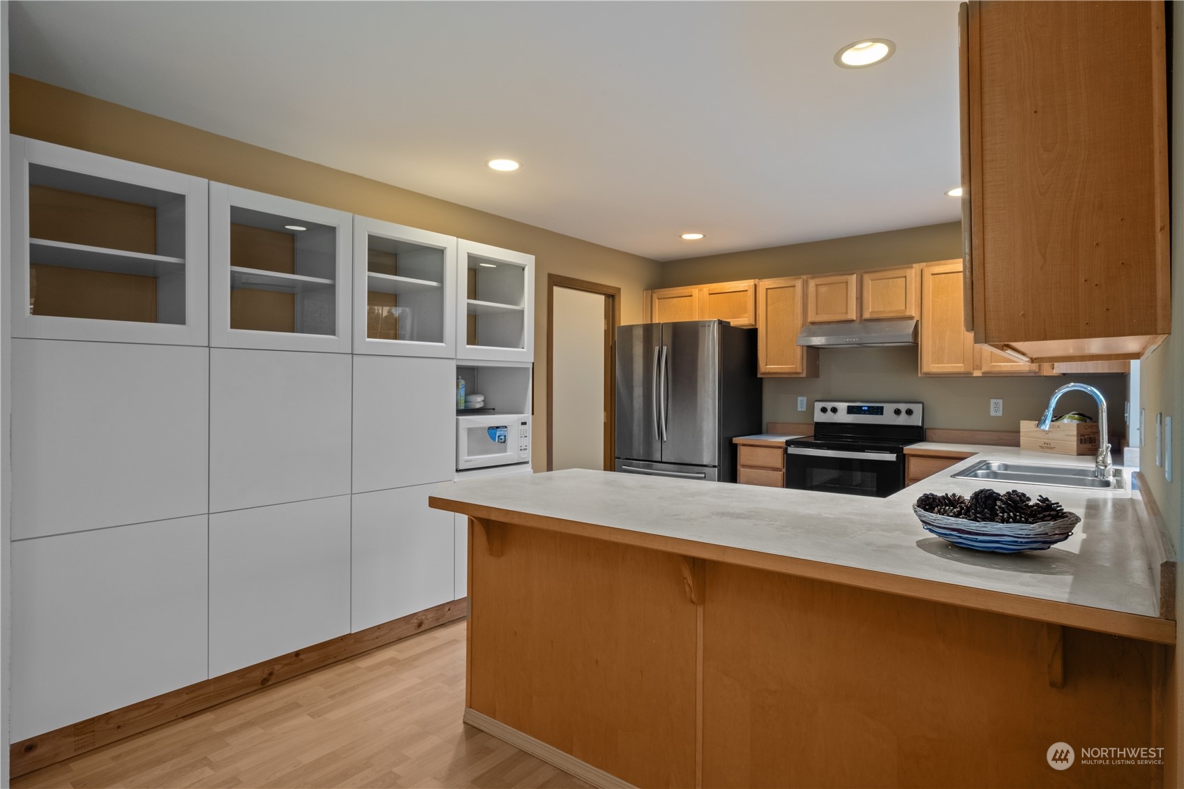 2306 Southeast 3rd Street Renton, WA 98056 - Photo 12 of 34 a kitchen with stainless steel appliances a refrigerator sink and cabinets