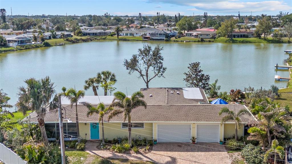 an aerial view of a house with a lake view