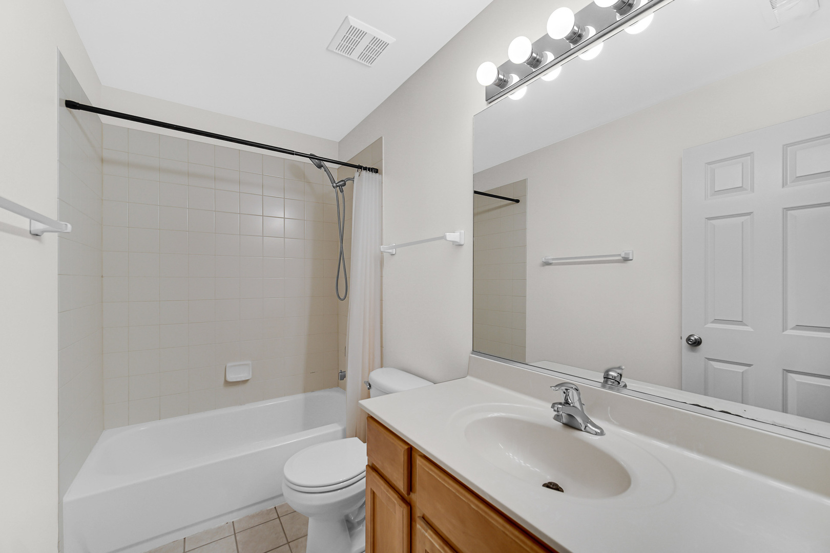 2331 Georgetown Circle Aurora, IL 60503 - Photo 11 of 20 a bathroom with a sink a toilet and a large mirror