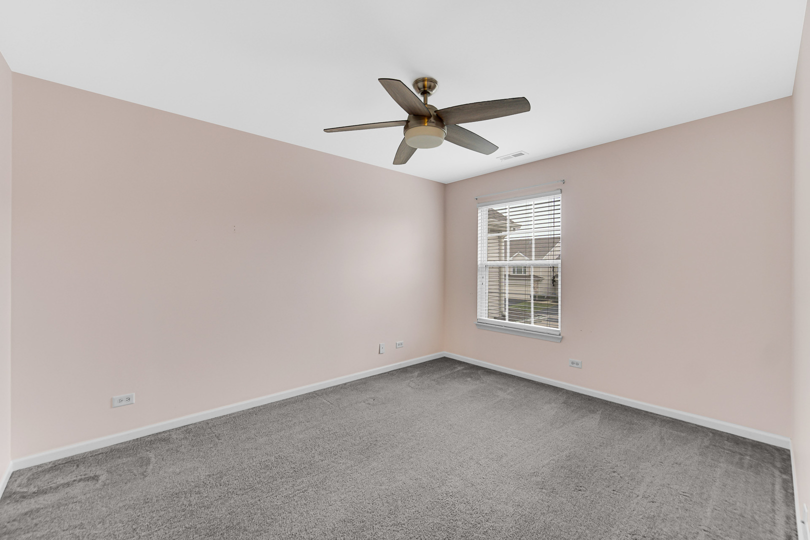 2331 Georgetown Circle Aurora, IL 60503 - Photo 17 of 20 an empty room with a ceiling fan and window
