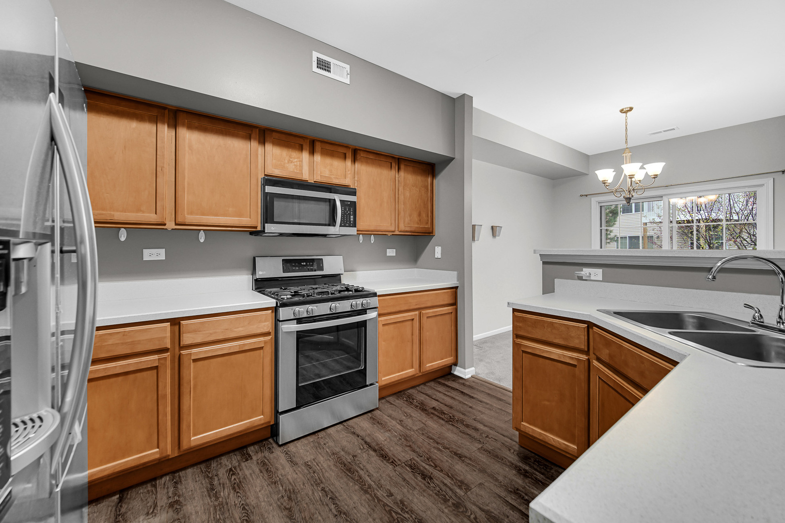 2331 Georgetown Circle Aurora, IL 60503 - Photo 7 of 20 a kitchen with stainless steel appliances granite countertop a stove a sink and a microwave