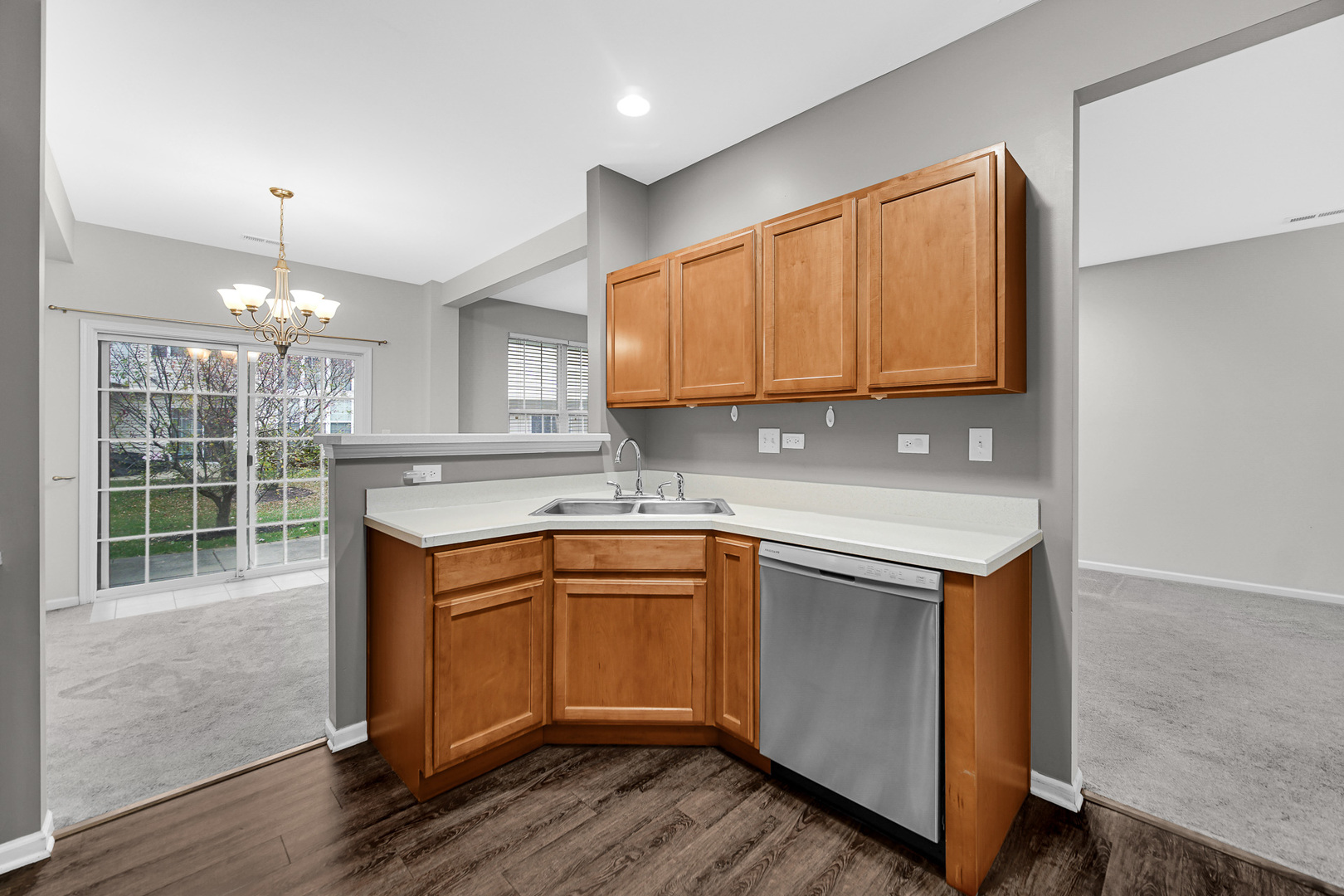 2331 Georgetown Circle Aurora, IL 60503 - Photo 8 of 20 a kitchen with stainless steel appliances granite countertop a sink a microwave cabinets and wooden floor