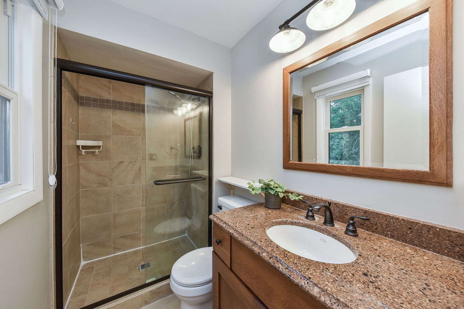 65 Redstart Road Naperville, IL 60565 - Photo 20 of 48 a bathroom with a granite countertop sink toilet mirror and shower