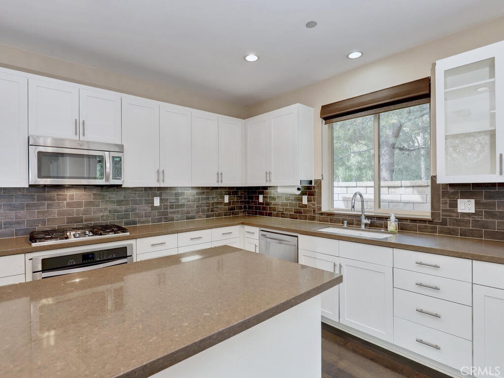 37 Clover Lake Forest, CA 92630 - Photo 8 of 75 a kitchen with stainless steel appliances granite countertop a sink a stove and cabinets